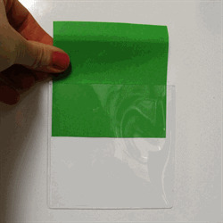 The white magnetic pockets can be difficult to see on a white background. With this green piece of paper, it can be easier to see the transparent front and the function of the pockets.