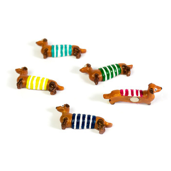 Waldi dog magnets from Trendform in different colors: Red, yellow, green, blue and turquoise stripes.